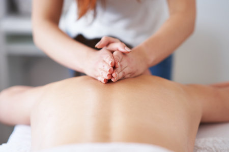 Brunette woman having back massage in salonの写真素材