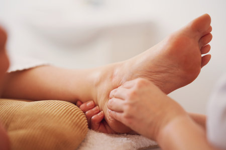 Woman having foot reflexology massage in salonの写真素材