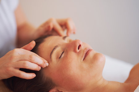 Woman having japan style face massage in salonの写真素材