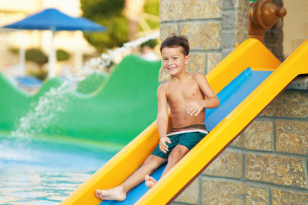 Picture of young boy playing in outdoor aqua parkの写真素材