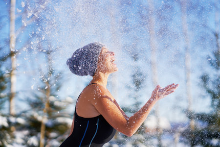 Picture of woman having fun on snow in winterの写真素材