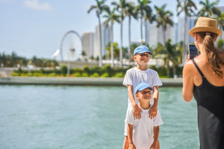 Picture from Miami of mother taking picture of sonsの写真素材