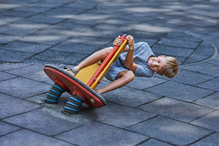 Photo of happy kid at playground outdoorの写真素材