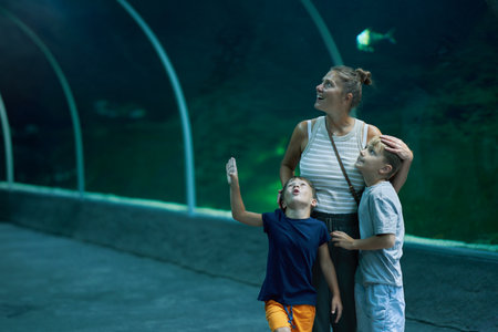 Photo of woman with kids in oceanarium zooの写真素材