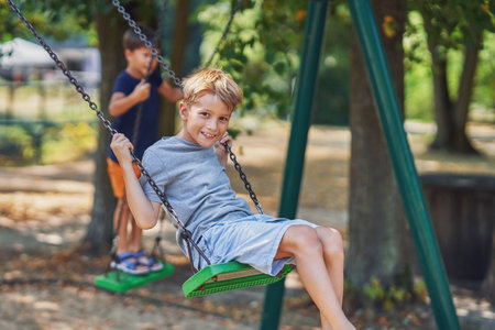 Photo of happy kid at playground outdoorの写真素材
