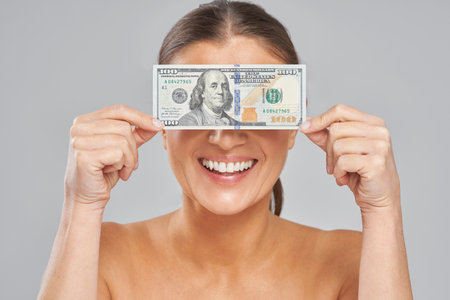 Photo of brunette woman holding billの写真素材