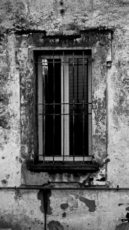 A window of a decaying buildingの写真素材
