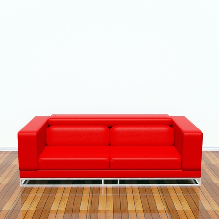 Red sofa on the floor behind a white wallの写真素材