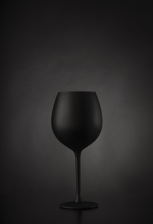 Black glass of wine on black backgroundの写真素材
