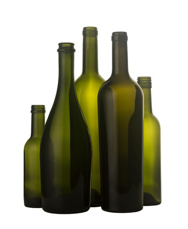 Vertical front view of a group of empty wine bottles of different sizes, shapes and colorisolated on white background.の写真素材