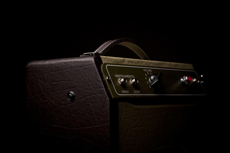 Horizotal picture of a leather finished guitar amplifier on black background viewed from the sideの写真素材