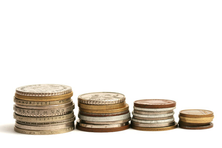 Old European coins of different currency on white backgroundの写真素材