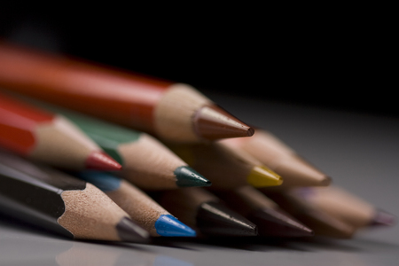Group of colored pencils with shallow depth of field on black backgroundの写真素材