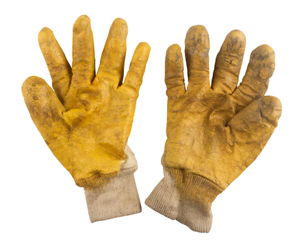 Used pair of gardening yellow gloves isolated on white backgroundの写真素材