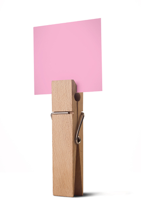 wooden peg holding a white note isolated on white backgroundの写真素材