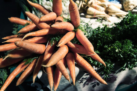 Horizontal front view of a bunch of fresh carrots in a market
