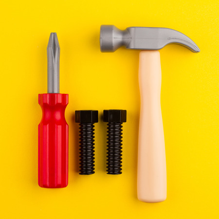 top view of plastic children toys isolated on yellow backgroundの写真素材