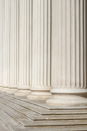vertical perspective view close up of classical building marble white columns with stairs