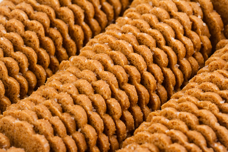 food background - low angle view closeup of round shaped sugar brown biscuits arranged in rowsの写真素材