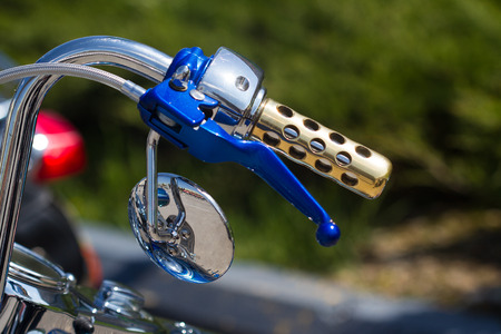 custom blue classic motorcycle handlebar detail isolated in white backgroundの写真素材
