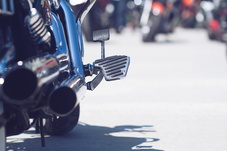 rear view of classical motorcycle pair of exhaust pipes and foot holder selective focusの写真素材