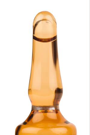 horizontal closeup of pharmaceutical ampoule top isolated on white backgroundの写真素材