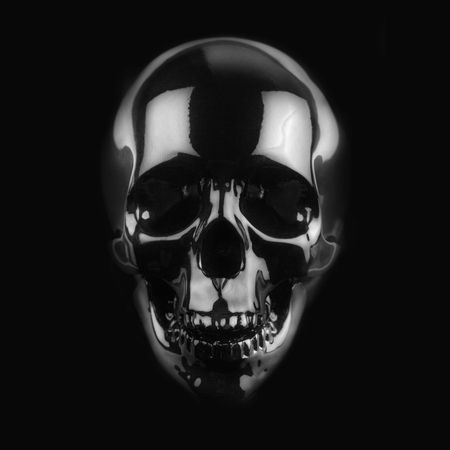 front view of polished shinny wooden skull on dark backgroundの写真素材