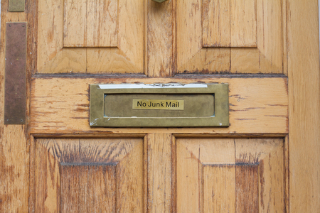 front view detail of residential wooden door with no junk mail inscription on itの写真素材