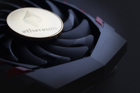 cryptocurrency mining concept with one golden Ethereum coin on top of a computer performant video...