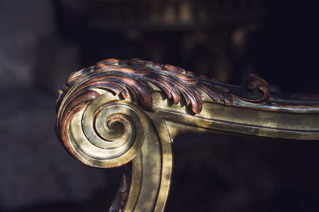 closeup detail front view  of old vintage wood armchair arm with wooden inlay nineteenth century antiqueの写真素材