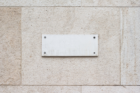 horizontal closeup of square empty marble plaque signboard on a building with classic architectureの写真素材