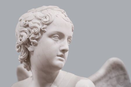 side view portrait of a classical angel face white sculpture marble on grey background