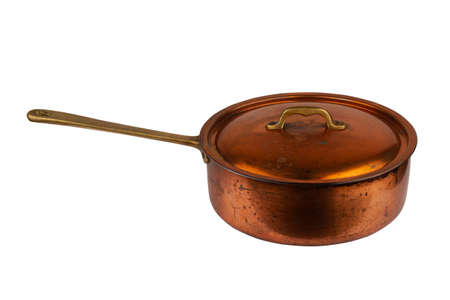 side view closeup of old cooking pan with copper lid and metallic handle isolated on white backgroundの写真素材