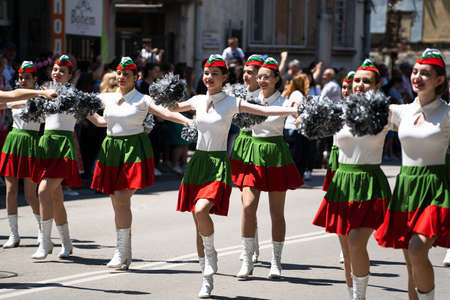 Kazanlak, Bulgaria - June 6, 2021: Young girls wearing the Bulgarian national colors dancing during...