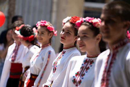 Kazanlak, Bulgaria - June 6, 2021: Young girls in traditional costumes during the annual Kazanlak Rose Festival parade when folklore groups local artists music bands and students show their creative abilities during a march through the center of the cityのeditorial素材