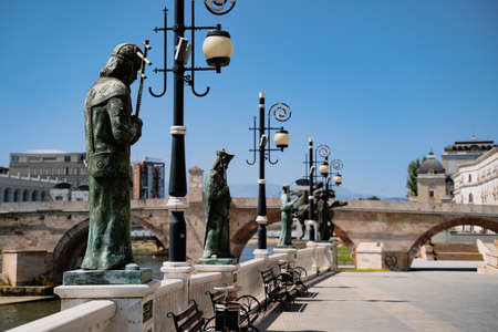 SKOPJE, NORTH MACEDONIA - AUGUST 19, 2021: Bronze statue of historical figures on Vardar river bridge in Skopjeのeditorial素材