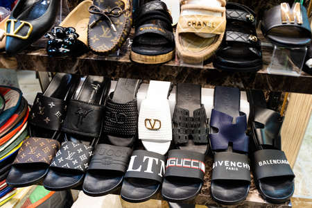 ISTANBUL, TURKEY - JULY 17, 2021: Close up of shelf with fake counterfeit famous fashion brand shoes...