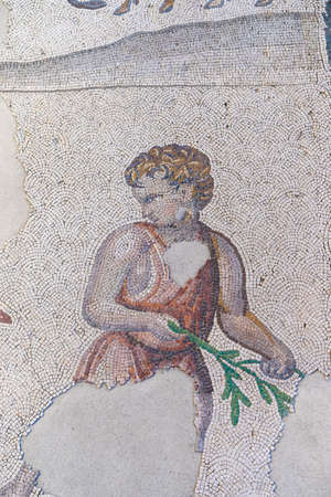 ISTANBUL, TURKEY - JULY 17, 2021: Scene with young man holding a green tree branch made with mosaic stones at the Museum of Great Palace Mosaics where Byzantine period mosaics from the Great Palace of Constantinople are featuredのeditorial素材