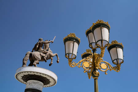 SKOPJE, NORTH MACEDONIA - AUGUST 19, 2021: Bronze sculpture of Alexander The Great in city central square against a blue skyのeditorial素材