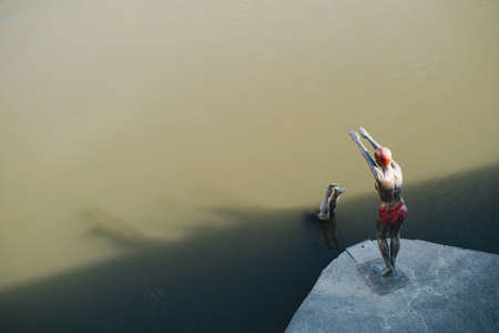 SKOPJE, NORTH MACEDONIA - AUGUST 19, 2021: Bronze sculpture of diving swimmer woman in bikini at Vardar riverのeditorial素材