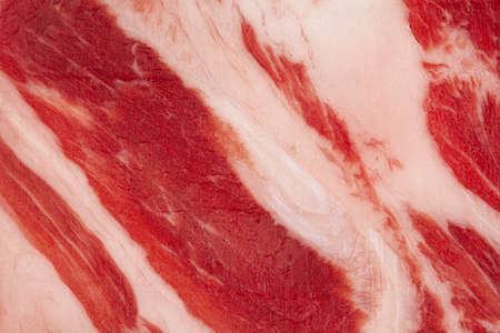 closeup detail of slice of smoked pork loin ham fillet with red color and white fat