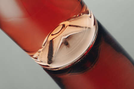 front view closeup of a rose wine bottle punt with reflection on shiny surfaceの写真素材