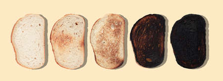 top view of slices of bread at different stages of toasting with last one completely charred and...