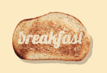 top view closeup slice of bread with word breakfast on it isolated on light brown backgroundの写真素材