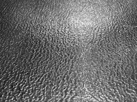 front view closeup of stainless steel plate metal flooring with embossed metallic pattern and shallow depth of fieldの写真素材