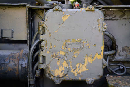 front view closeup of rusted metallic cabinet panel enclosure with peeled off paintの写真素材