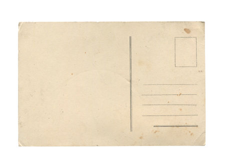 front view closeup of old vintage empty aged paper postcard texture with faded stamp print and brown stains isolated on whiteの写真素材