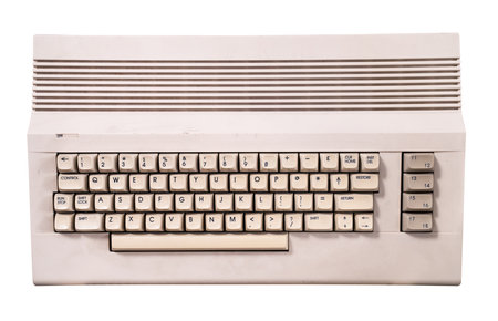 top view closeup of vintage cream colored home computer keyboard isolated on white