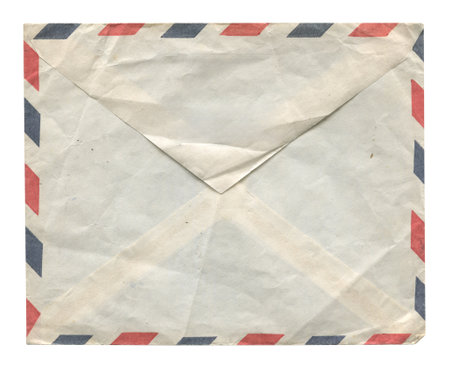 front view closeup of blank brown old aged closed letter paper envelope with antique texture and airmail stripes isolated on white backgroundの写真素材