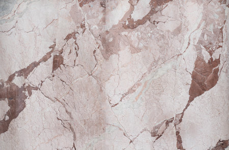 A detailed closeup of marble texture showing natural beige and brown veins and cracksの写真素材